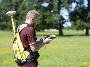 Student using GIS equipment in field