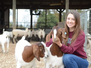 Student in pen with goats