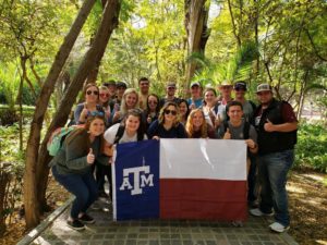Aggie students holding flag