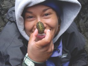 Girl holding insect to her nose