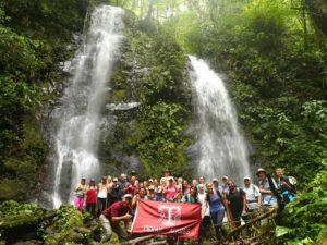 Student group picture in front of a waterfall