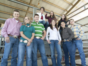 Students posing together in a barn