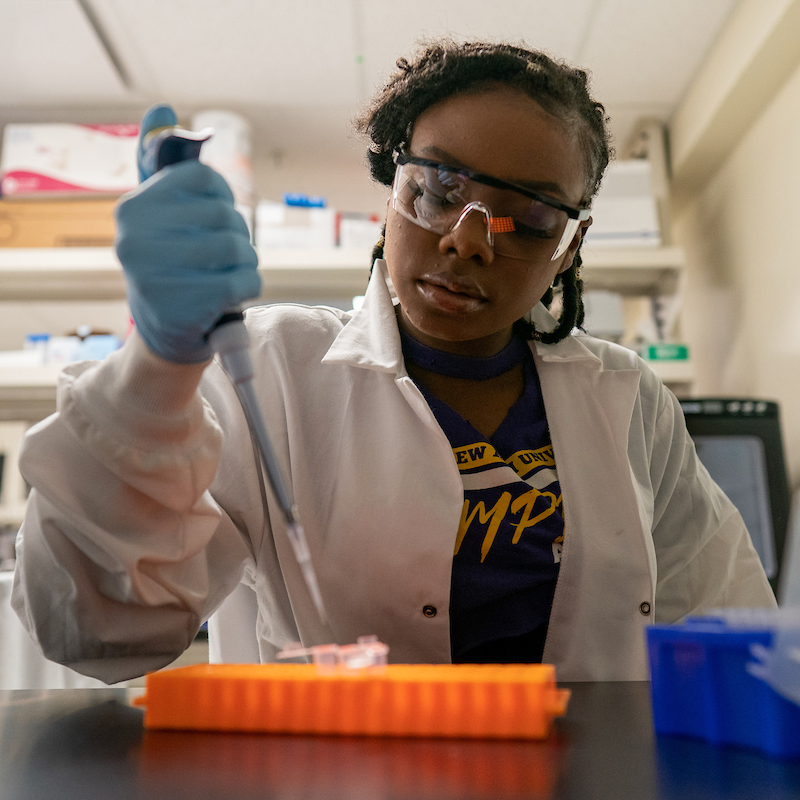 Undergraduate Terezan Lewis working in her lab