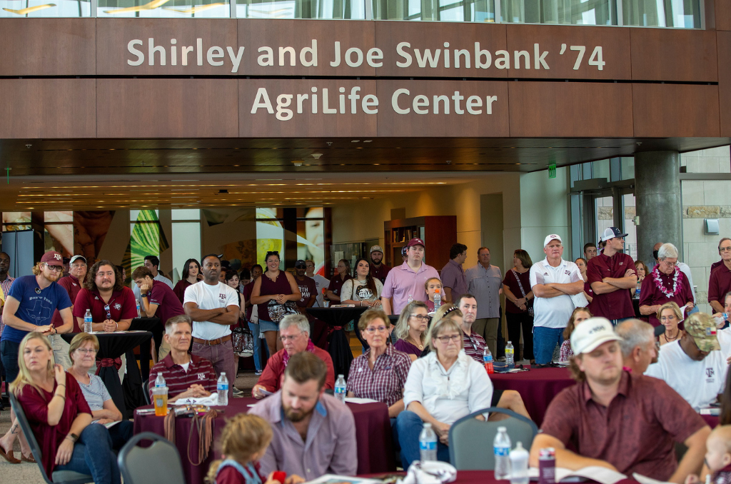 Former Students sitting at tables in the Texas A&M AgriLife Center