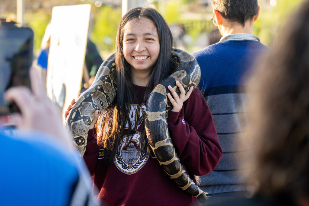 Girl holding a live python