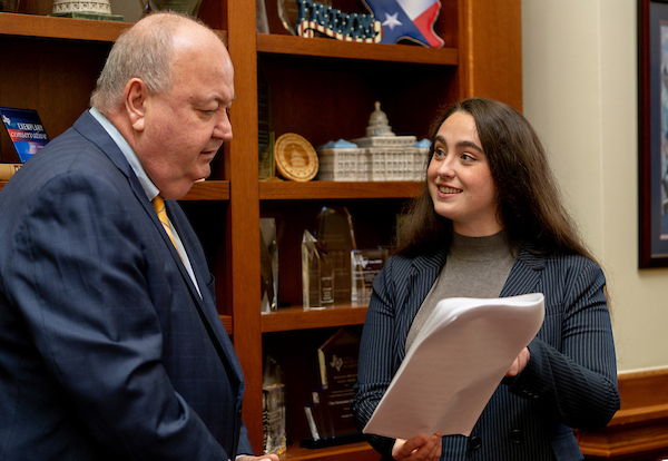 A female intern shares a document with her supervisor